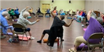 Group of people enjoying a chair yoga class.