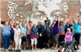 Group of people with their hands up on a tour in Detroit.
