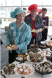 Seniors Queue up at the Desserts Table During a Tea Party Social