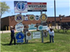 Two Seniors Beside the Welcome to Westland Sign