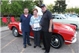 Woman Presents Award to Two Mens Red Retro Car