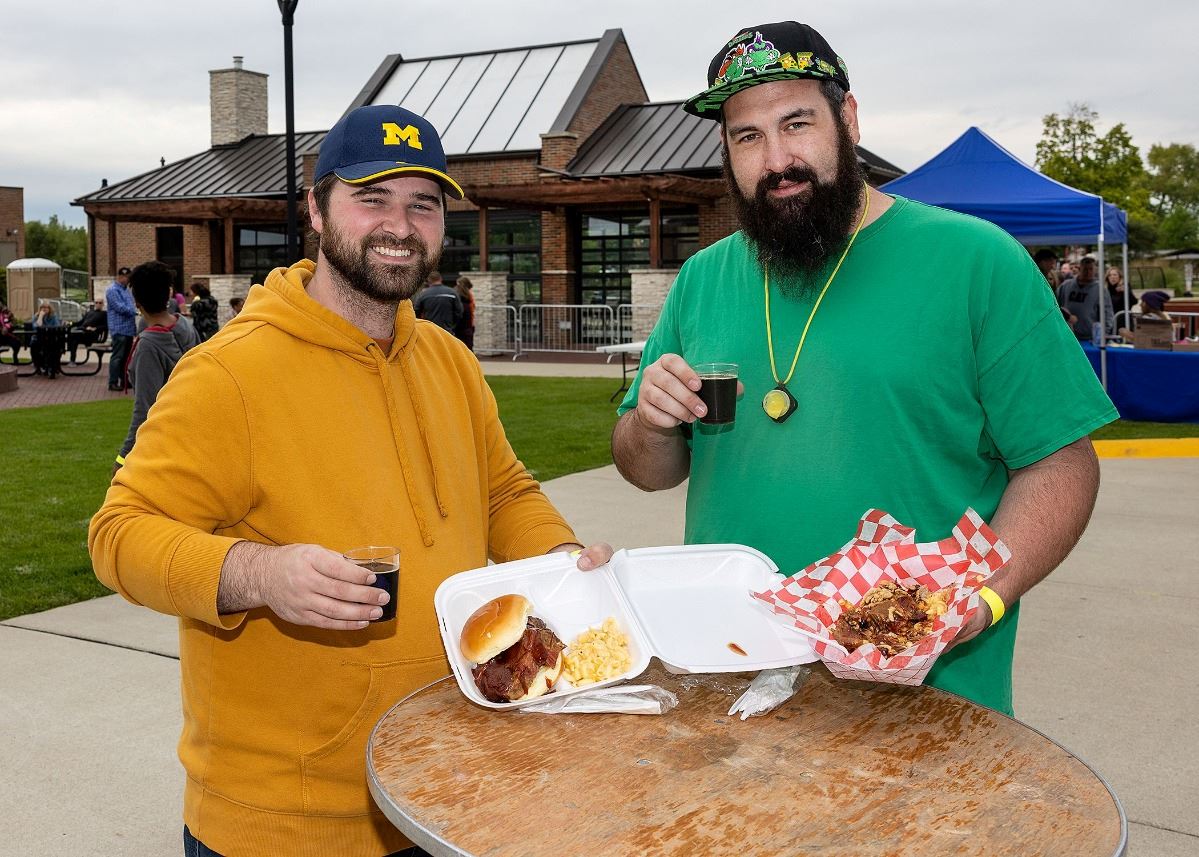Two men with food at the Craft Beer and Wine Festival