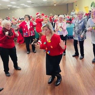 Christmas Party 2023 Woman dancing with Christmas lightbulb necklace